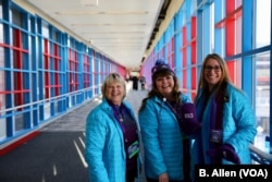 Sharri Murphy poses with other local volunteers who are helping to guide visitors through the elaborate downtown Skyway.