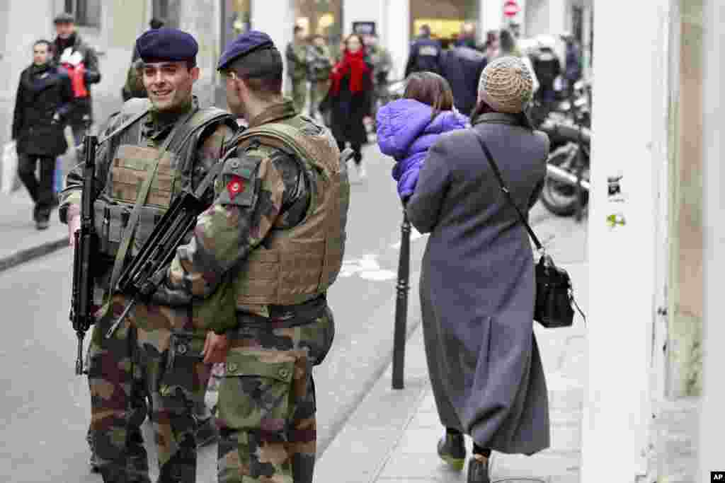 French army soldiers patrol Rue des Rosiers in the heart of the Paris Jewish quarter, Jan. 12, 2015.