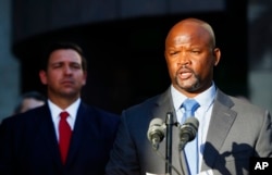 Acting sheriff Gregory Tony, right, speaks after being introduced by Florida Gov. Ron DeSantis, left, at the Broward County Sheriff's Office Fort Lauderdale headquarters in Florida, Jan. 11, 2019.
