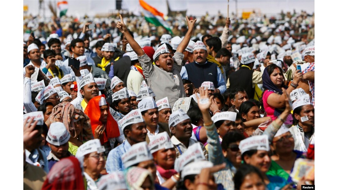FILE - Supporters of Aam Aadmi Party (AAP) cheer after its chief, Arvind Kejriwal, took an oath as the new chief minister of Delhi in New Delhi, Feb. 14, 2015. The 2-year-old anti-graft party took office promising to fight divisive politics in a challenge