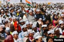 FILE - Supporters of Aam Aadmi Party (AAP) cheer after its chief, Arvind Kejriwal, took an oath as the new chief minister of Delhi in New Delhi, Feb. 14, 2015. The 2-year-old anti-graft party took office promising to fight divisive politics in a challenge