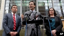 Attorney General Bob Ferguson, center, stands with Solicitor General Noah Purcell, left, and Civil Rights Unit Chief Colleen Melody as he speaks with media members on the steps of the federal courthouse after an immigration hearing there, March 15, 2017, 