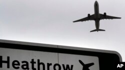 FILE - A plane takes off over a road sign near Heathrow Airport in London, June 5, 2018.
