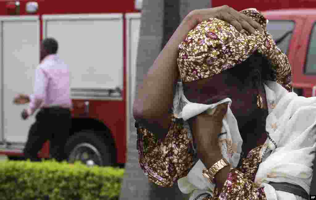 An unidentified victim weeps after a bomb blast that ripped through the United Nations offices in the Nigerian capital of Abuja August 26, 2011. The blast happened after a car rammed into the building, and witnesses said they had seen a number of dead bod