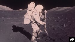 FILE - Astronaut Harrison H. Schmitt collects lunar rake samples during the Apollo 17 mission, Dec. 13, 1972.