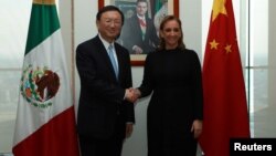 Mexico's Foreign Minister Claudia Ruiz Massieu shakes hands with Chinese State Councillor Yang Jiechi after attending a private meeting at the foreign ministry building in Mexico City in this undated Mexican Foreign Ministry handout photo, Dec. 12, 2016. 
