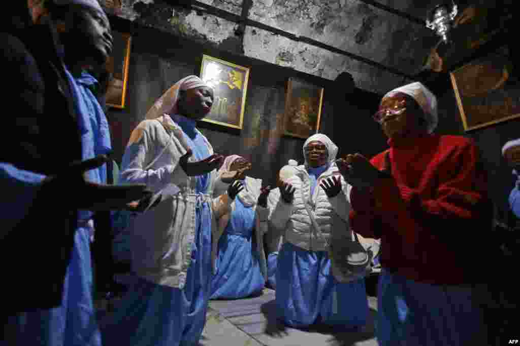 Christian pilgrims pray in the Grotto of the Church of the Nativity on Christmas Eve in the biblical West Bank city of Bethlehem.