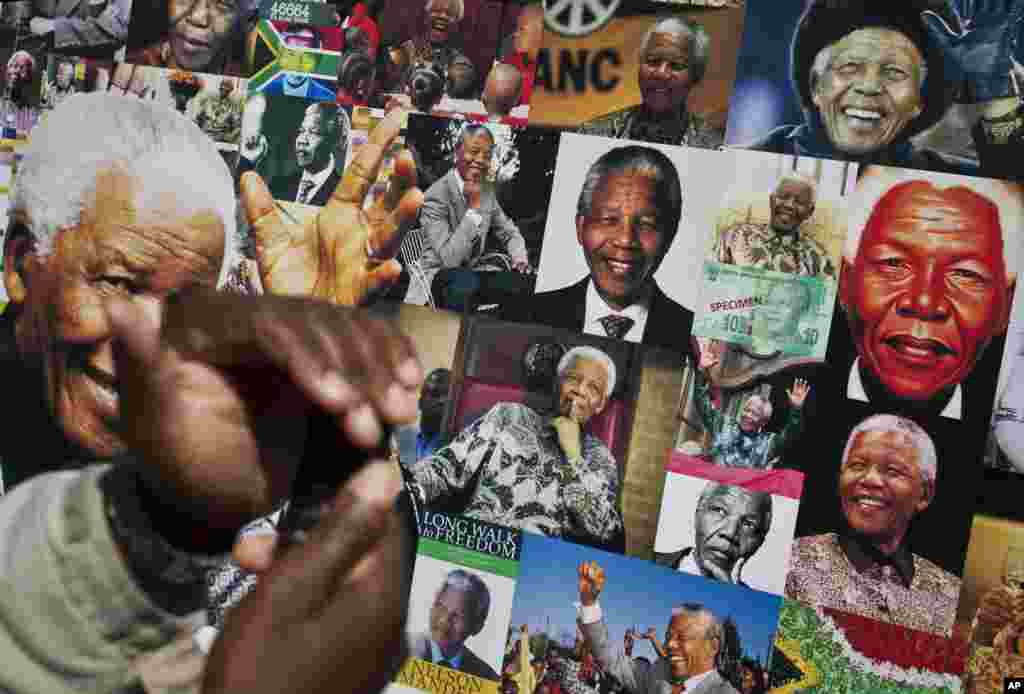 A banner of photos of Nelson Mandela set up outside the Mediclinic Heart Hospital in South Africa, July 18, 2013.