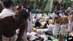 Muslim pilgrims gather around the victims of a stampede in Mina, Saudi Arabia during the annual hajj pilgrimage, Sept. 24, 2015.