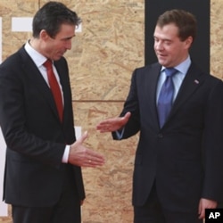 NATO Secretary General Anders Fogh Rasmussen, left, and Russian President Dmitry Medvedev are seen prior to participating in a NATO Russia Council meeting at a NATO summit in Lisbon (file photo)
