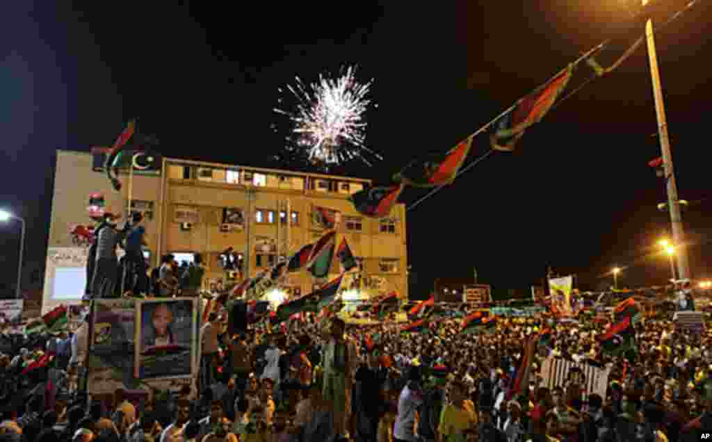 Fireworks explode as people gather near the courthouse in Benghazi on Aug. 22, 2011 to celebrate the takeover of Tripoli by rebel fighters. (Reuters)
