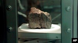 FILE - The meteorite labeled ALH84001 sits in a chamber at a Johnson Space Center lab in Houston, Aug. 7, 1996. Scientists say they've confirmed the meteorite from Mars contains no evidence of ancient Martian life. 