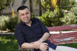 Iraqi born refugee Bilal Alobaidi and new U.S. citizen, poses for a photo Friday, Sept. 4, 2020, in Phoenix, (AP Photo/Ross D. Franklin)