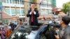 FILE - Cambodia's main opposition Cambodia National Rescue Party Deputy President and National Assembly Deputy President Kem Sokha greets to his supporters outside the Phnom Penh Municipality Court in Phnom Penh, Wednesday, April 8, 2015.