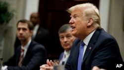 President Donald Trump listens during a roundtable with lawmakers in the Roosevelt Room of the White House, Aug. 23, 2018, in Washington.