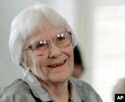 FILE - Author Harper Lee smiles during a ceremony honoring the four new members of the Alabama Academy of Honor at the Capitol in Montgomery, Alabama, Aug. 20, 2007.