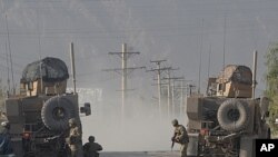 US soldiers keep watch on site during a gunfight near a US base in Kandahar on October 27, 2011.