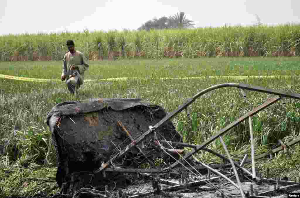 A rescue official walks near the wreckage of a hot air balloon that crashed in Luxor, Egypt, Feb. 26, 2013.