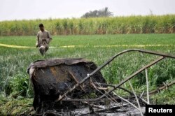 FILE - A rescue official walks near the wreckage of a hot air balloon that crashed in Luxor, Egypt, Feb. 26, 2013.