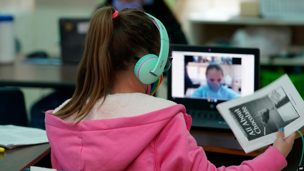 Students at Driggers Elementary School attend a class in-person as they interact with classmates virtually, Monday, Feb. 8, 2021, in San Antonio. (AP Photo/Eric Gay)