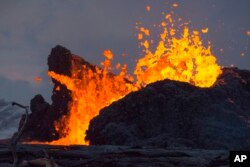 In this May 24, 2018, photo from the Federal Emergency Management Agency, lava erupts from a fissure in the Leilani Estates neighborhood near Pahoa on the island of Hawaii.