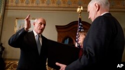 Vice President Mike Pence administers the oath of office to Homeland Security Secretary John Kelly in the Vice Presidential Ceremonial Office in the Eisenhower Executive Office building on the White House grounds in Washington, Jan. 20, 2017.