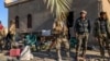 Fighters with the Syrian Democratic Forces gather in a position in the eastern Syrian province of Deir el-Zour, March 9, 2019.