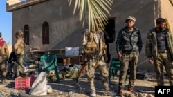 Fighters with the Syrian Democratic Forces gather in a position in the eastern Syrian province of Deir el-Zour, March 9, 2019.