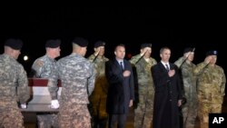 In this Monday, Nov. 7, 2016 file photo, an Army carry team moves a transfer case containing the remains of Staff Sgt. James Moriarty, past Army Secretary Eric Fanning, center, Undersecretary of Defense for Intelligence Marcel Lettre, third from right, and Gen. Daniel B. Allyn, right, Army vice chief of staff, at Dover Air Force Base, Del. According to the Department of Defense, Moriarty, 27, of Kerrville, Texas, died of wounds sustained on Nov. 4, in Jordan.