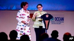Indonesian Minister of Foreign Affairs Retno Marsudi, right, stands with Indonesian Minister of Marine Affairs and Fisheries Susi Pudjiastuti while speaking during the opening of the Our Ocean Conference in Bali, Indonesia, Oct. 29, 2018.