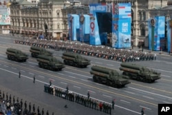 FILE - Russian S-400 Triumf surface-to-air missile systems roll during a dress rehearsal for the Victory Day military parade in Red Square in Moscow, Russia, May 7, 2021.