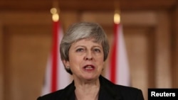 FILE - Britain's Prime Minister Theresa May makes a statement about Brexit in Downing Street in London, March 20, 2019.