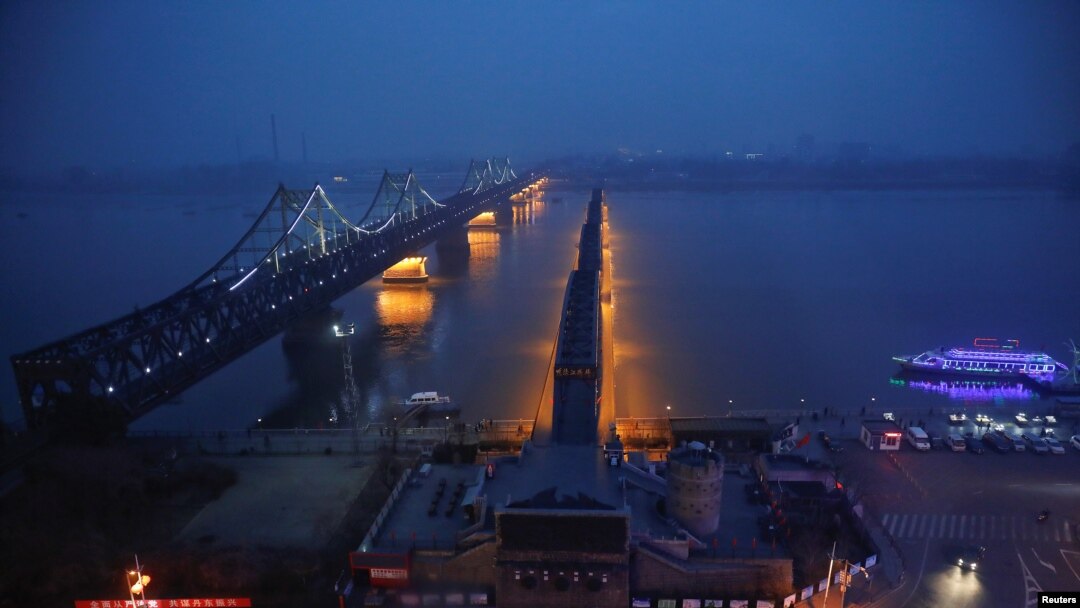 Lights are turned on on the Friendship and the Broken bridges over the Yalu River connecting the North Korean town of Sinuiju and Dandong in China's Liaoning province, March 30, 2017.