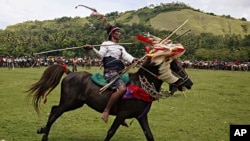 A rider prepares to throw a blunted spear during the Pasola festival on the Indonesian island of Sumba