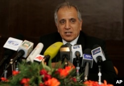 FILE - US politician Zalmay Khalilzad speaks during a news conference.