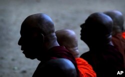 Buddhist monks pray during a ceremony to invoke blessings on the dead and wounded from Sunday's bombings at the Kelaniya temple in Colombo, Sri Lanka, April 24, 2019.