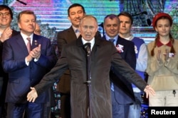 Russian President Vladimir Putin addresses the crowd during a concert marking the fifth anniversary of Russia's annexation of Crimea, in Simferopol, March 18, 2019.
