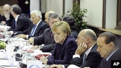German Chancellor Angela Merkel, center, attends a round table during an EPP party meeting ahead of an EU summit in Brussels, 16 Dec 2010