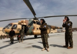 FILE - Female soldiers of the Afghan Air Force wait at the International Airport in Kabul, March 7, 2013.