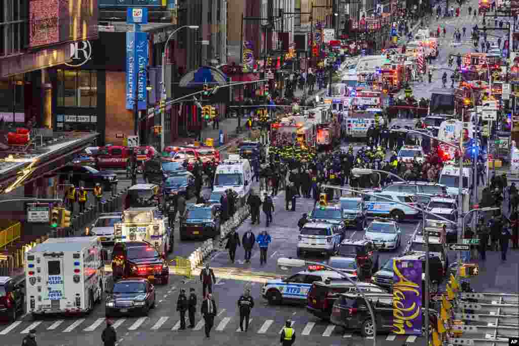Law enforcement officials work following an explosion near New York&#39;s Times Square. Police said a man with a pipe bomb strapped to his body set off the crude device in a passageway under 42nd Street between Seventh and Eighth Avenues.