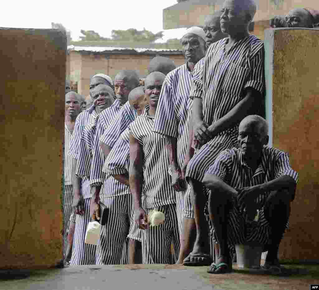 Kenyan prisoners wait in line to vote in Kisumu, on Lake Victoria. This is the first time that inmates in Kenya are permitted to vote. Kenyans began voting in general elections headlined by a too-close-to-call battle between incumbent Uhuru Kenyatta and his rival Raila Odinga, sparking fears of violence in east Africa&#39;s richest economy.