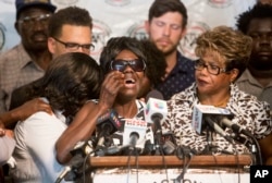 FILE - Pamela Benge, center, spoke of her son, Alfred Olango, at a press conference in San Diego, Calif., Sept. 29, 2016, to address the killing of Olango, a Ugandan refugee shot by an El Cajon police officer two days earlier.