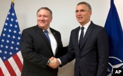 U.S. Secretary of State Mike Pompeo, left, shakes hands with NATO Secretary-General Jens Stoltenberg prior to a meeting at NATO headquarters in Brussels, April 27, 2018.