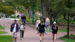 Students walk to and from classes on the Indiana University campus, Oct. 14, 2021, in Bloomington, Indiana.