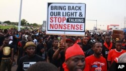FILE - People are seen protesting against power cuts in Accra, May 16, 2015.