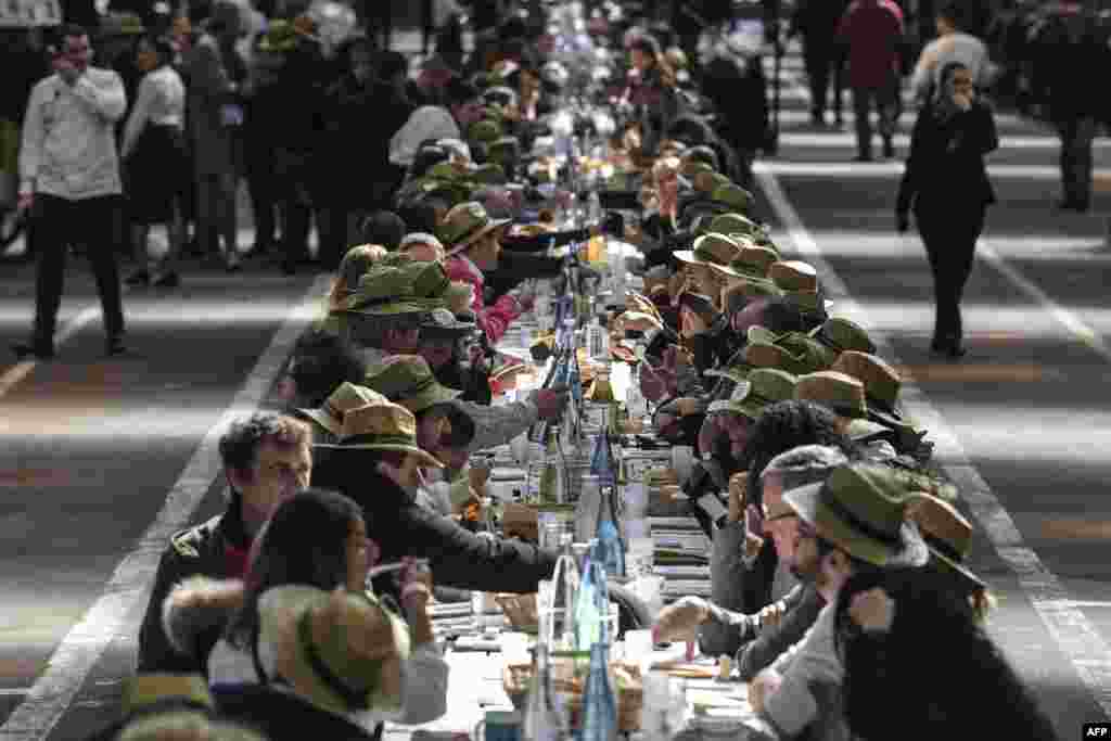 People take part in an attempt to break the Guinness World Records of the longest table to celebrate the international food market of Rungis&#39; 50th anniversary, on March 17, 2019 in Rungis, outside Paris, France.