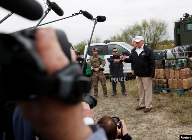 U.S. President Donald Trump talks to the media as he stands with U.S. Border Patrol agents on the banks of the Rio Grande River during his visit to the U.S.-Mexico border in Mission, Texas, Jan. 10, 2019.