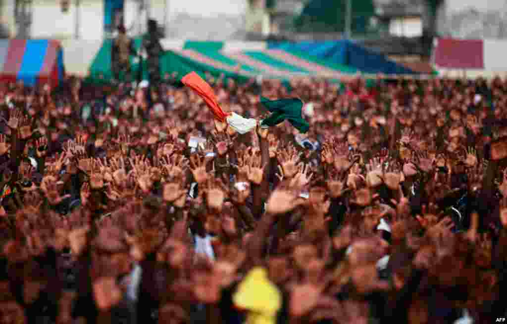 Dec. 29: Supporters of Ivory Coast's incumbent leader Laurent Gbagbo hold an Ivory Coast national flag during a rally in Yopougon, Abidjan. The European Union will tighten sanctions against Gbagbo next month, expanding a list of his supporters to be targe