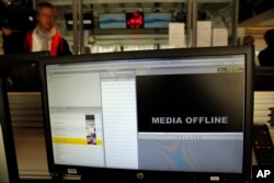 FILE - A computer screen is pictured at TV5 Monde after the French television network was hacked by people claiming allegiance to the Islamic State group, in Paris, France, April 9, 2015.