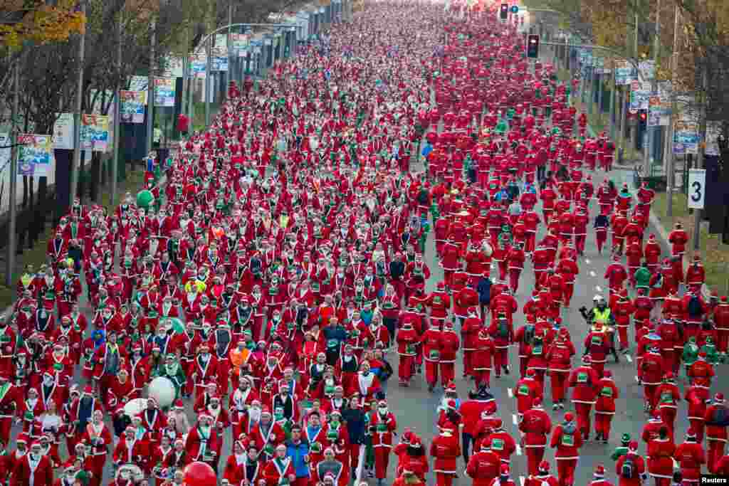 Participants dressed as Santa Claus take part in a charity race in Madrid, Spain.